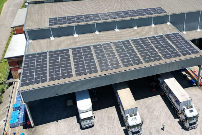 An aerial perspective of Crusader Logistics trucks parked in truck ports with solar panels on the roof