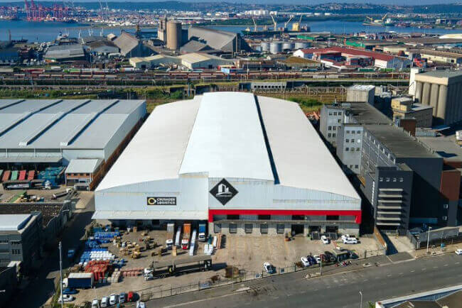 An aerial shot of the Crusader Logistics Sydney Road warehouse with Durban harbor in the background